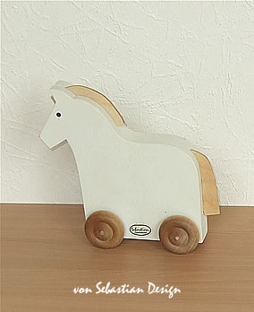 1 small white horse on rolls, 13 cm